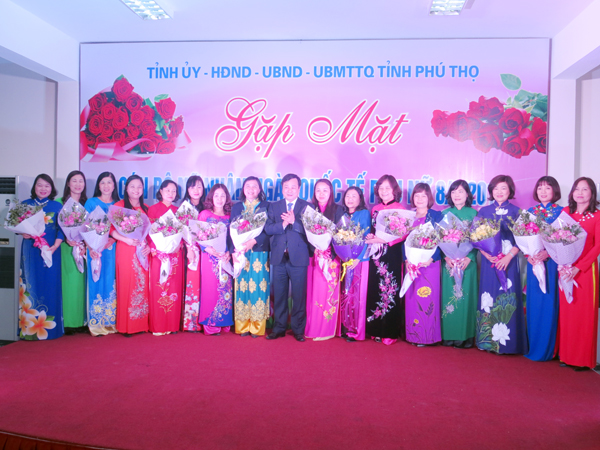 Phó Bí thư Thường trực Tỉnh ủy Bùi Văn Quang tặng hoa và quà chúc mừng những cán bộ nữ.